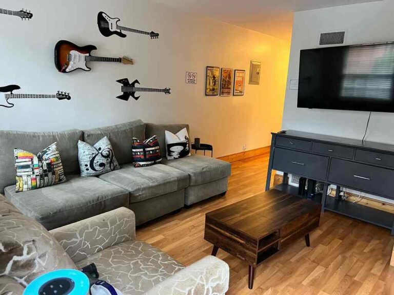 Spotless living room with clean hardwood floors, freshly dusted entertainment center, and well-maintained furniture showcasing premium residential cleaning services in Charlotte and Raleigh NC