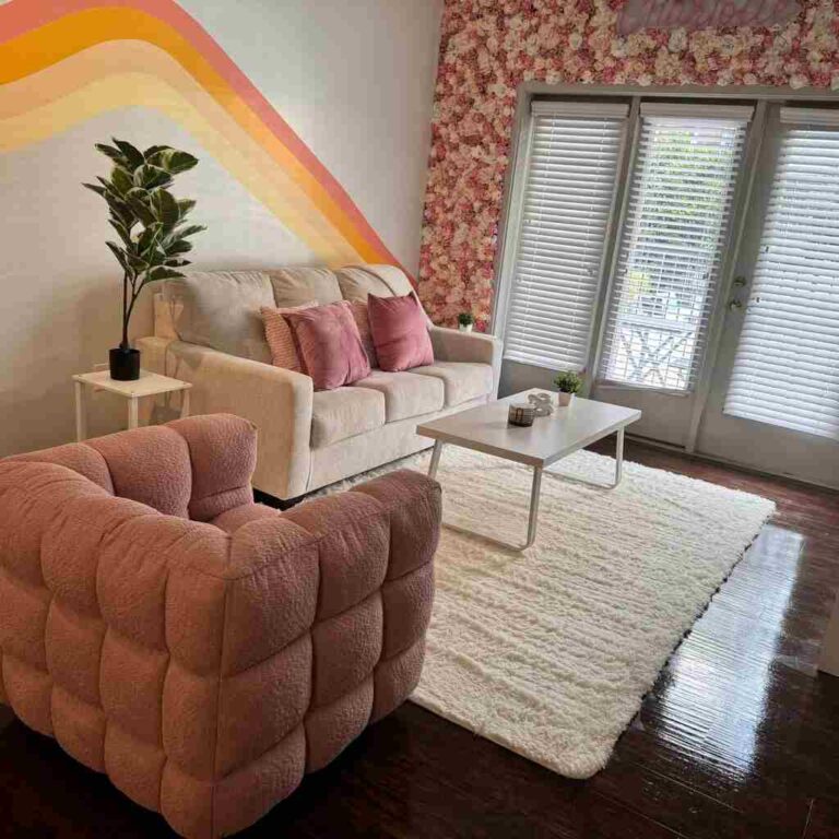 Immaculate living room with spotless hardwood floors, perfectly cleaned floral accent wall, sparkling windows, and pristine furniture showcasing expert residential cleaning services in Raleigh and Charlotte NC